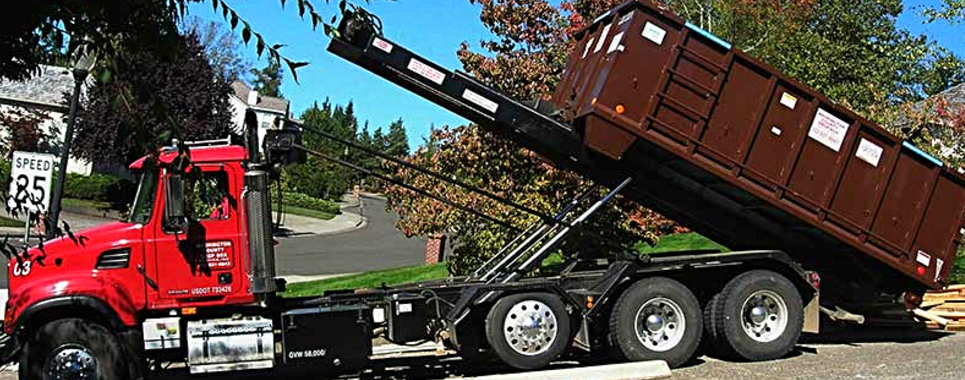 Red dump truck with elevated cargo bed on a residential street